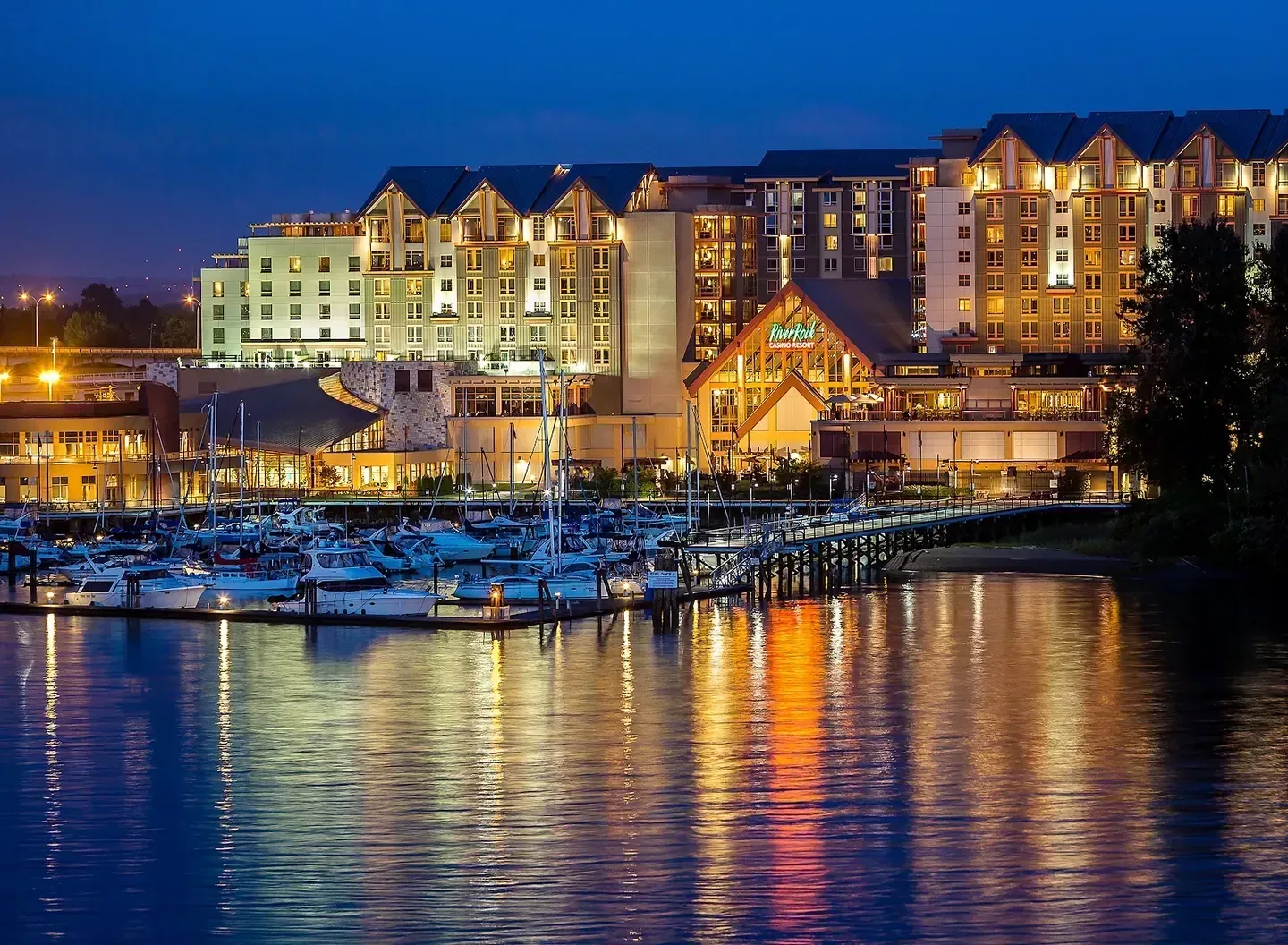 River Rock Casino Resort illuminated at dusk above its marina, Richmond